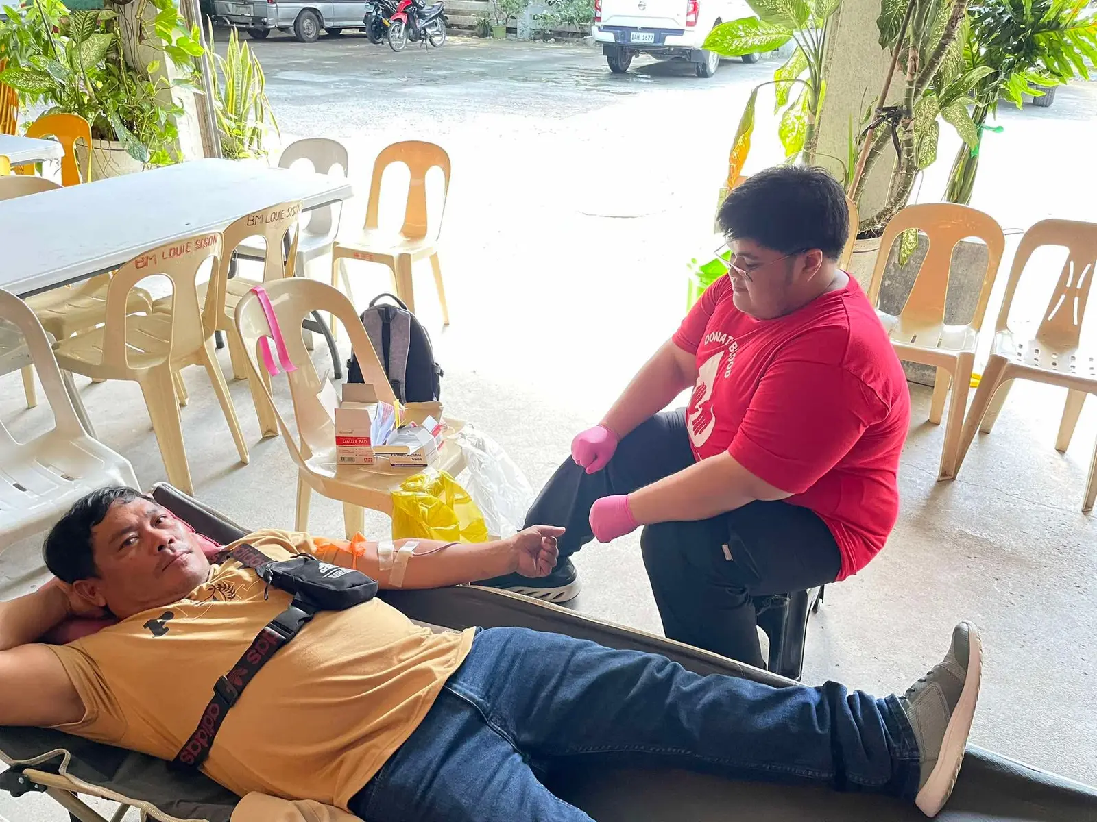 John assisting a participant during a community medical mission